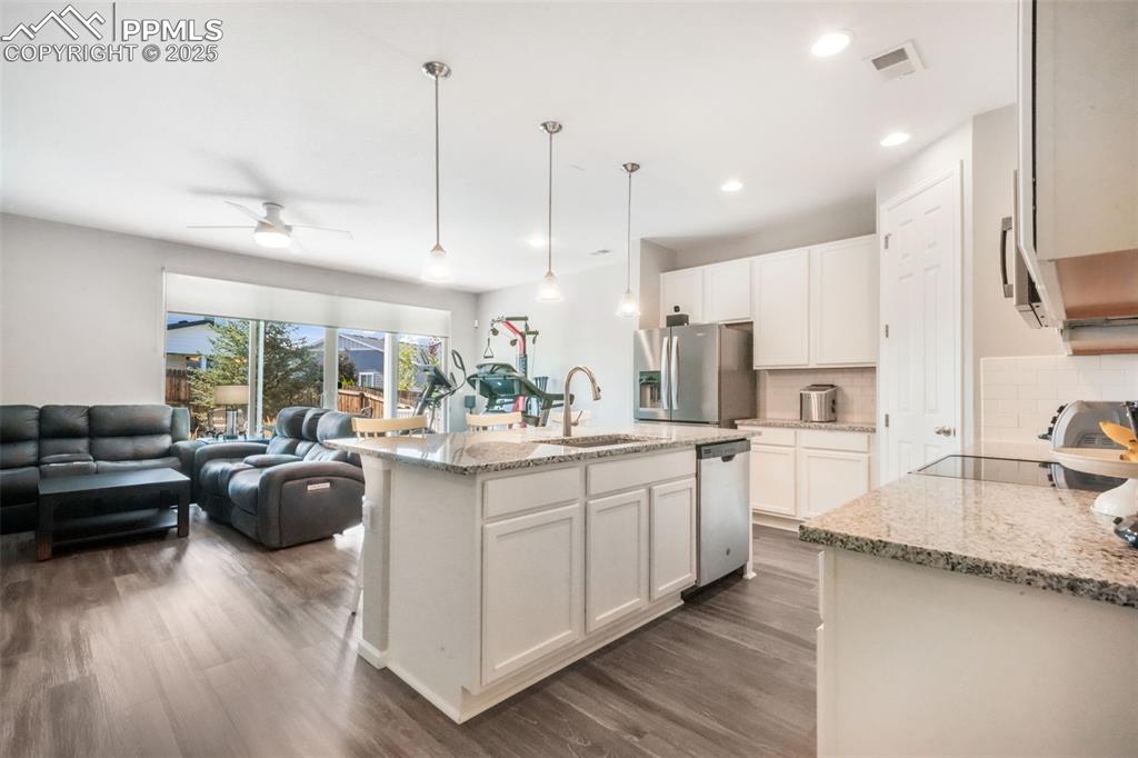 Image 12 of 47: Granite counters, large island with oversized sink, stainless steel applian