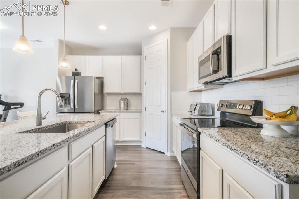 Image 13 of 47: Granite counters, large island with oversized sink, stainless steel applian