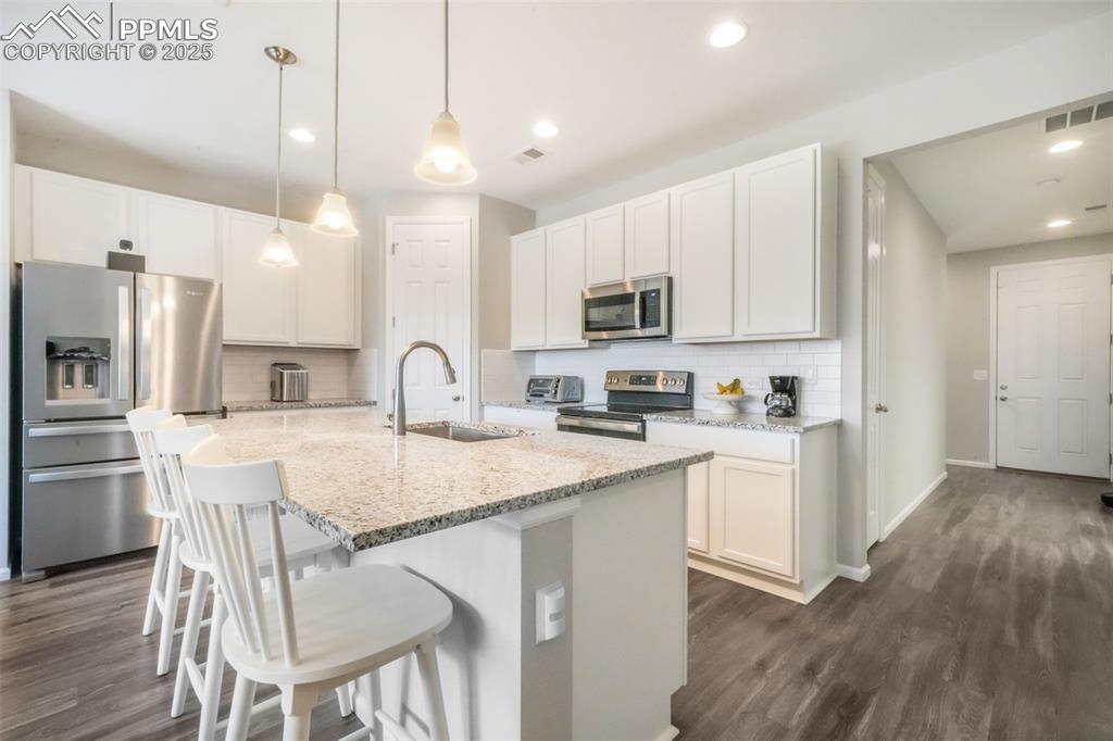 Image 14 of 47: Granite counters, large island with oversized sink, stainless steel applian