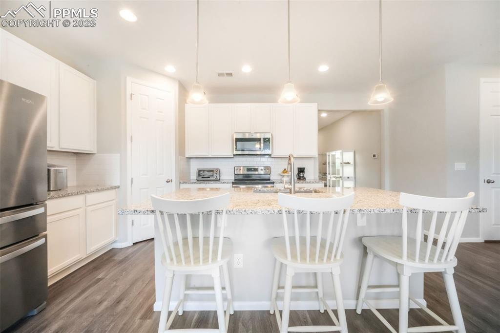 Image 15 of 47: Granite counters, large island with oversized sink, stainless steel applian