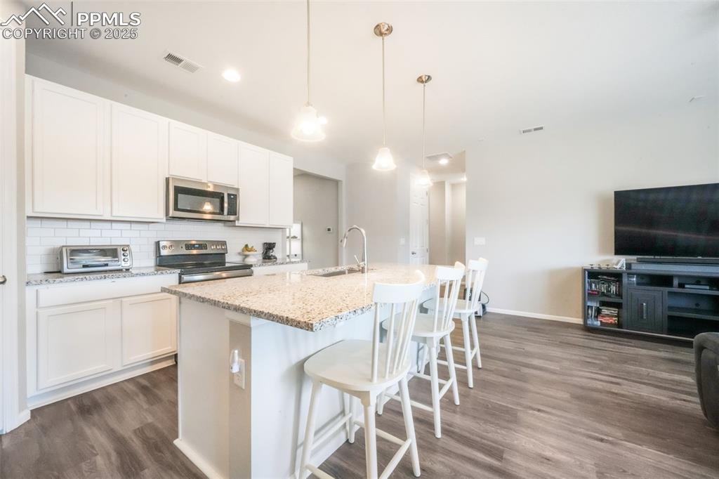 Image 16 of 47: Granite counters, large island with oversized sink, stainless steel applian