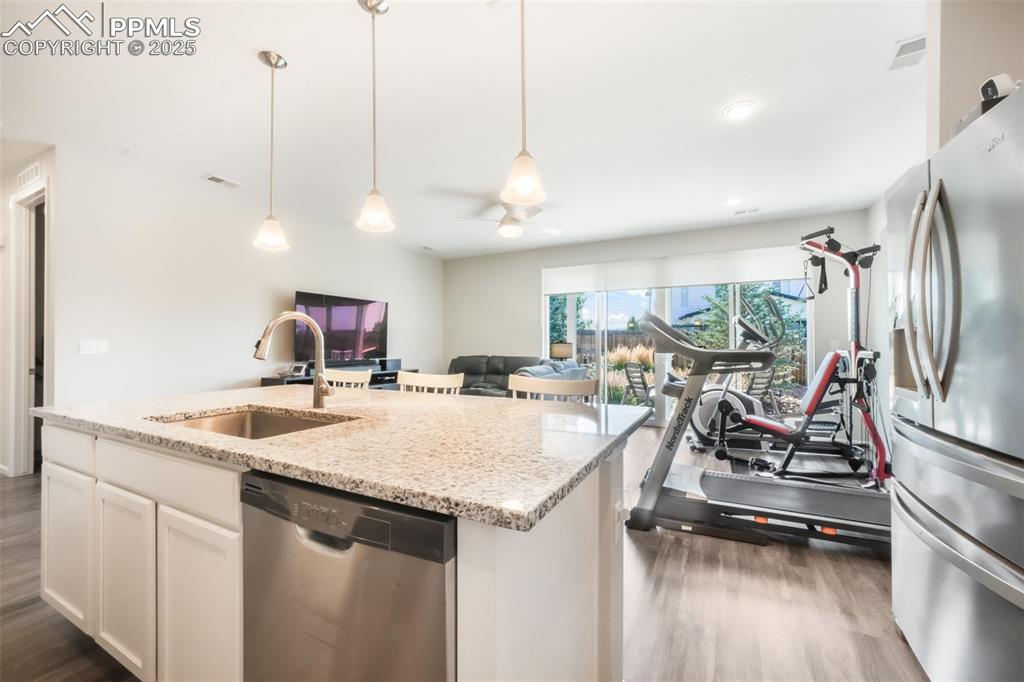 Image 18 of 47: Granite counters, large island with oversized sink, stainless steel applian