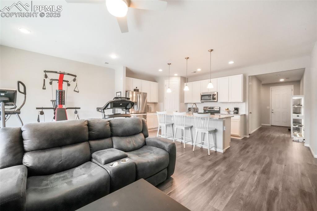 Image 19 of 47: Large open living room with access thru double sliding doors out to covered