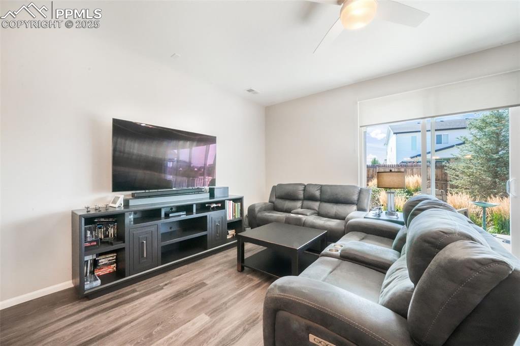 Image 20 of 47: Large open living room with access thru double sliding doors out to covered