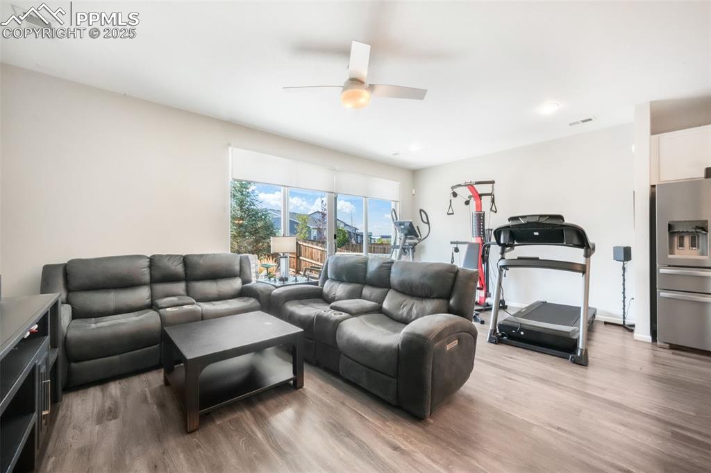 Image 21 of 47: Large open living room with access thru double sliding doors out to covered