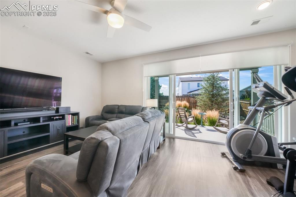 Image 22 of 47: Large open living room with access thru double sliding doors out to covered