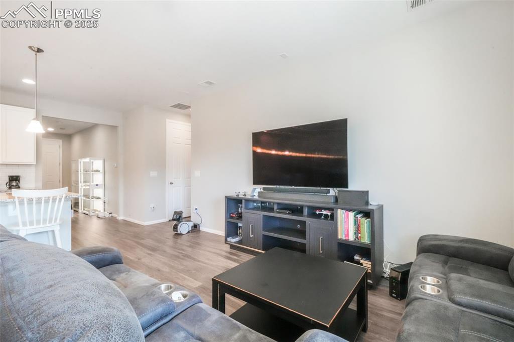 Image 23 of 47: Large open living room with access thru double sliding doors out to covered