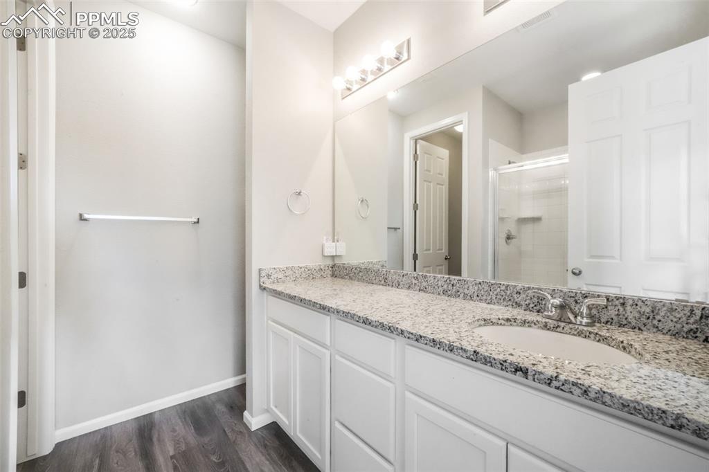 Image 30 of 47: Primary bathroom with large shower, granite counters and already plumbed fo