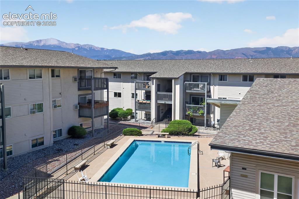 Image 24 of 38: Outdoor swimming pool with surrounding fencing