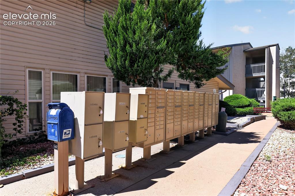 Image 33 of 38: Community mailbox station with a dedicated postal collection box, a paved p