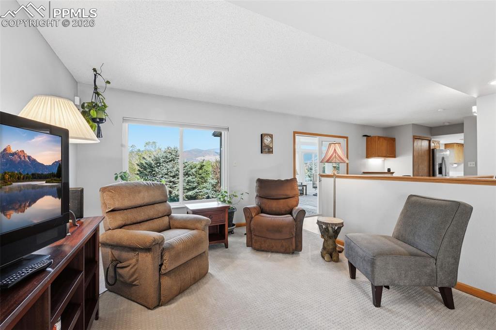 Image 15 of 49: Family room is light and bright with view of the Mountains!