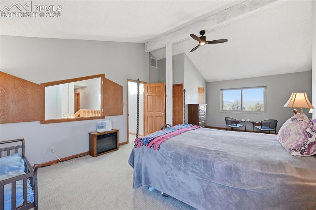 Image 18 of 49: With vaulted ceilings and views of Pikes Peak your bedroom oasis awaits!
