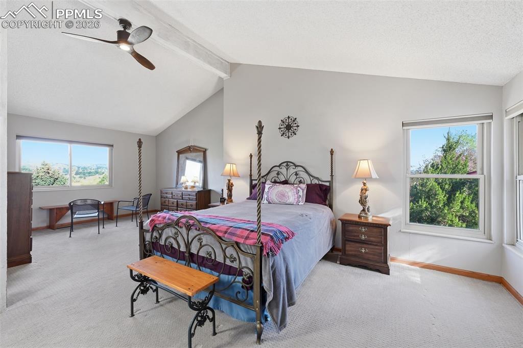 Image 19 of 49: Vaulted ceilings make the primary bedroom feel grand!