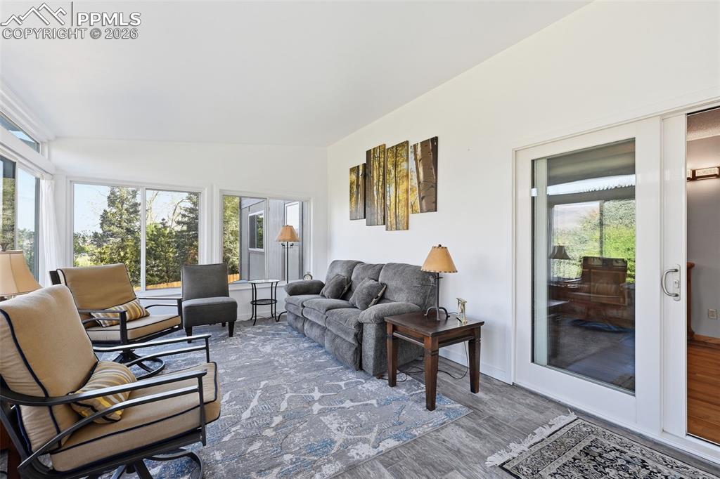 Image 31 of 49: This Custom Sunroom features wrap around windows and views of the entire fr