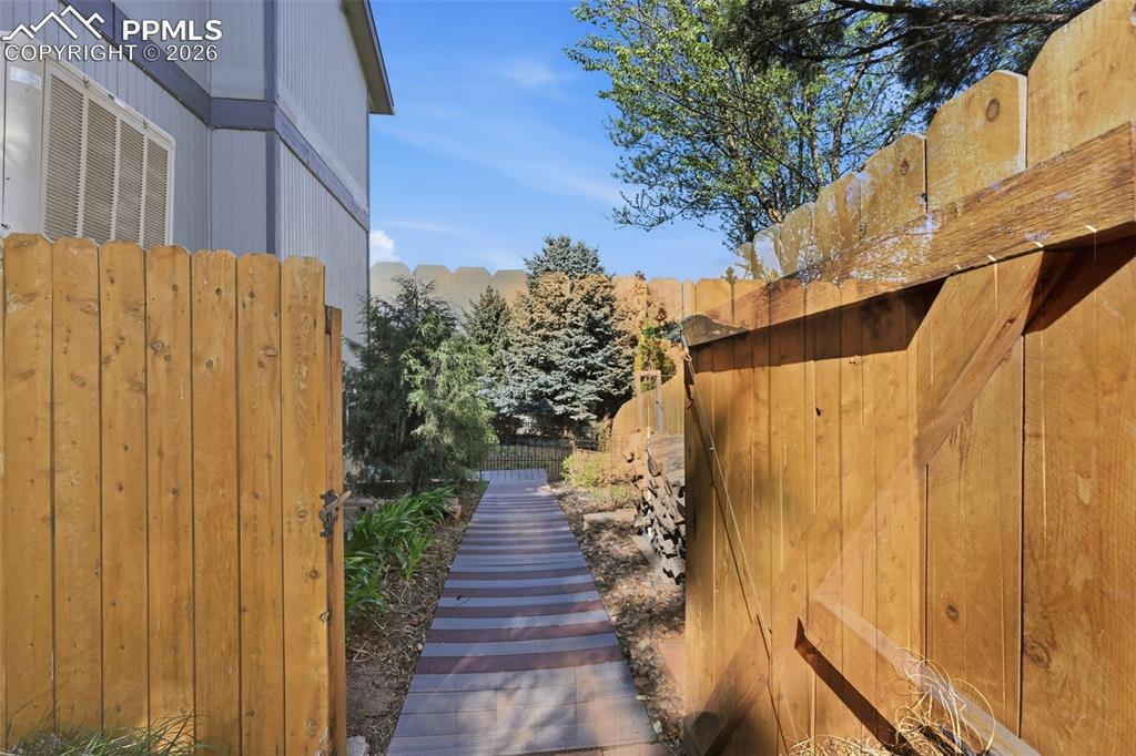 Image 36 of 49: This is the gated entry to the walkway to the basement apartment. 
