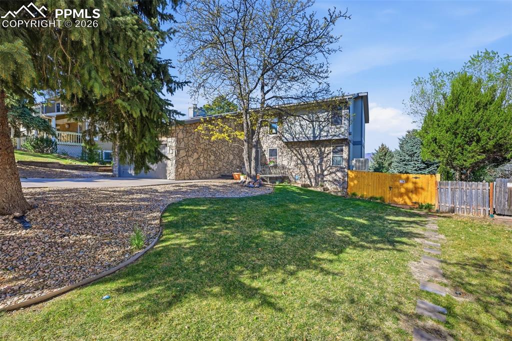 Image 39 of 49: There is a paver walk way to the gated entrance to the Basement Apartment. 