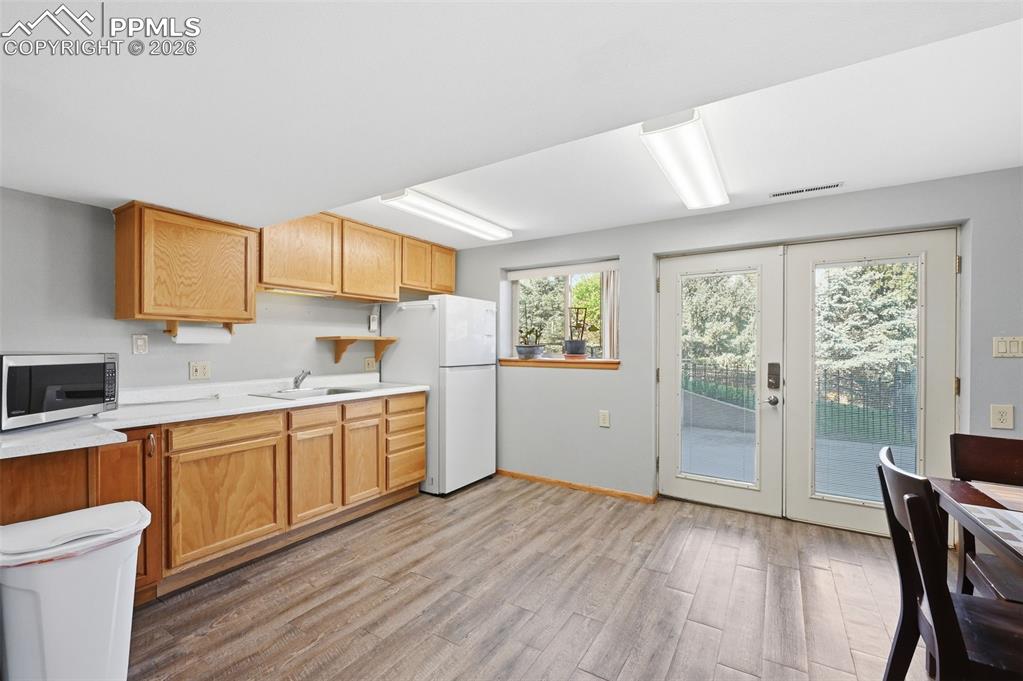 Image 40 of 49: This is the kitchenette in the Basement Apartment. The French Doors lead ou