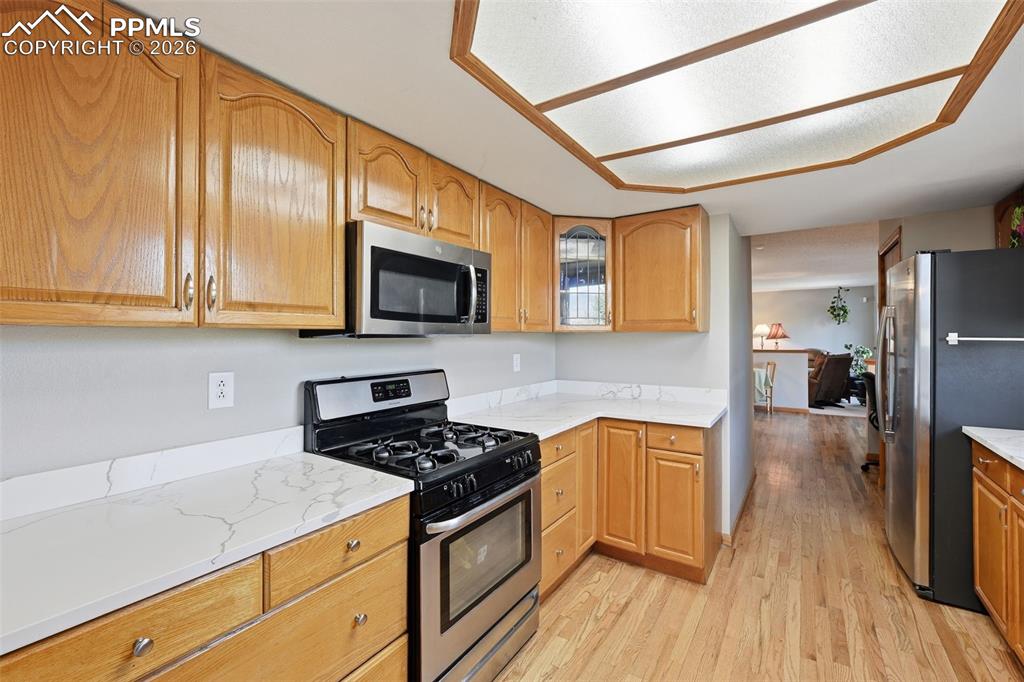 Image 7 of 49: The Kitchen features this stunning veined quartz counter tops, true luxury!