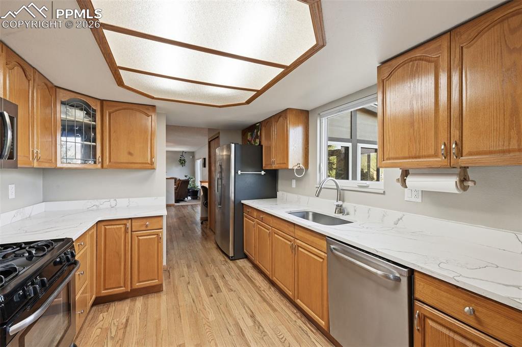 Image 8 of 49: Lots of cabinet space and views of Pikes Peak from your kitchen window!