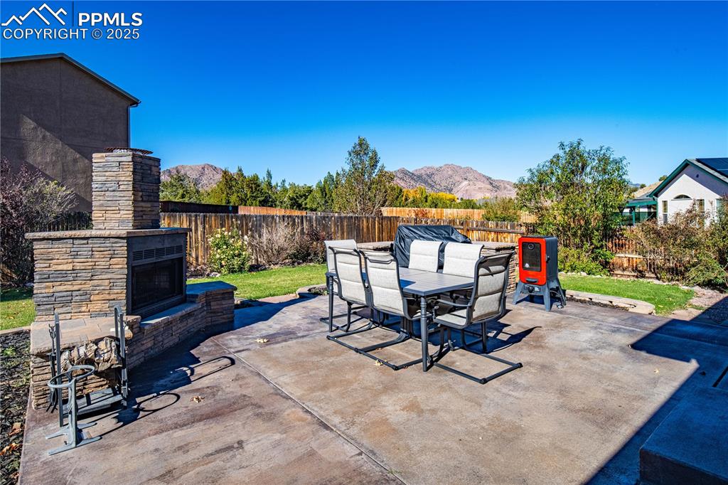 Image 11 of 35: Back patio with fireplace