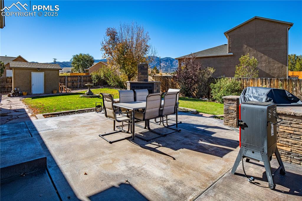 Image 12 of 35: Stone surround for grill on stained concrete patio