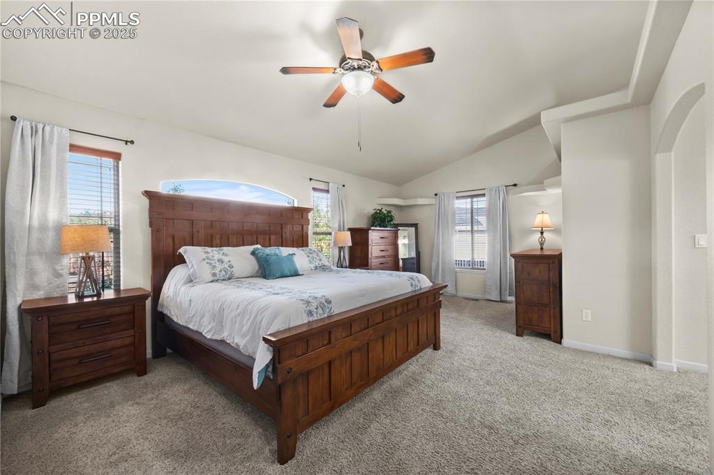 Image 15 of 35: Lots of natural light, plush carpet and ceiling fan in the primary bedroom