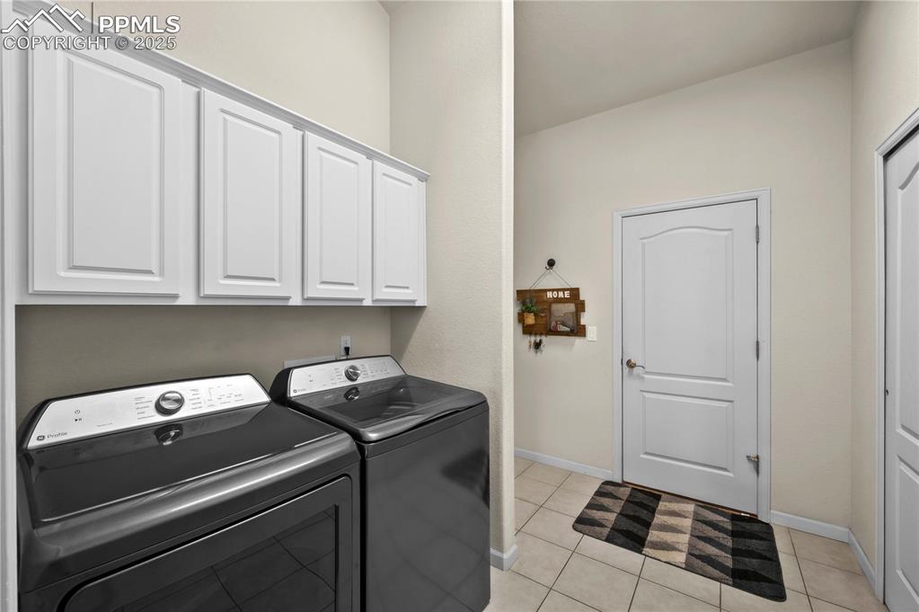 Image 22 of 35: Laundry area with built-in cabinets and two-way storage closet/hallway clos