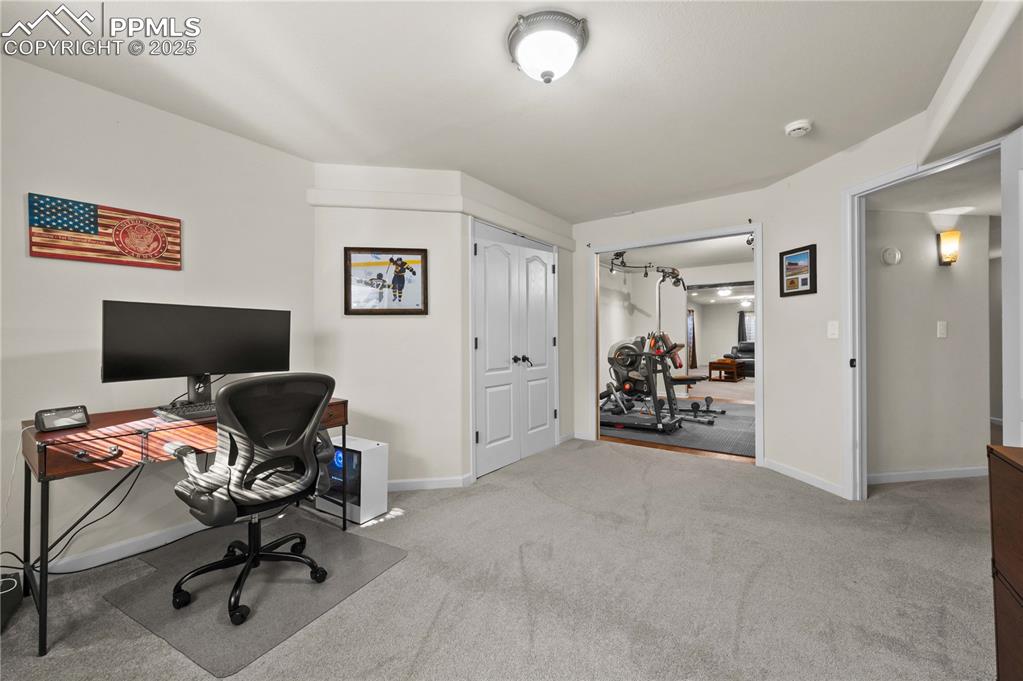 Image 27 of 35: Office has entry points from both the exercise room and hallway.