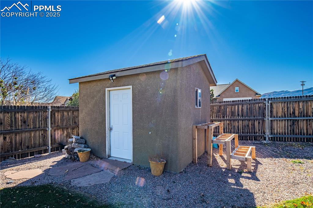 Image 31 of 35: Gardening shed in backyard