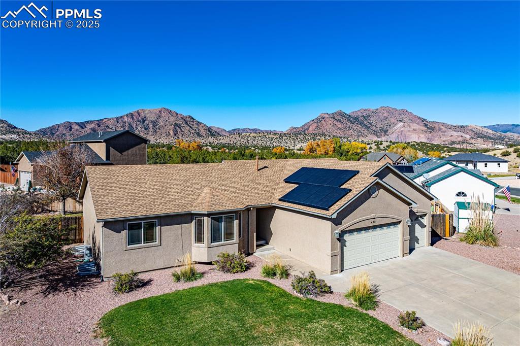 Image 35 of 35: Solar panel system and manicured front yard with mountain views