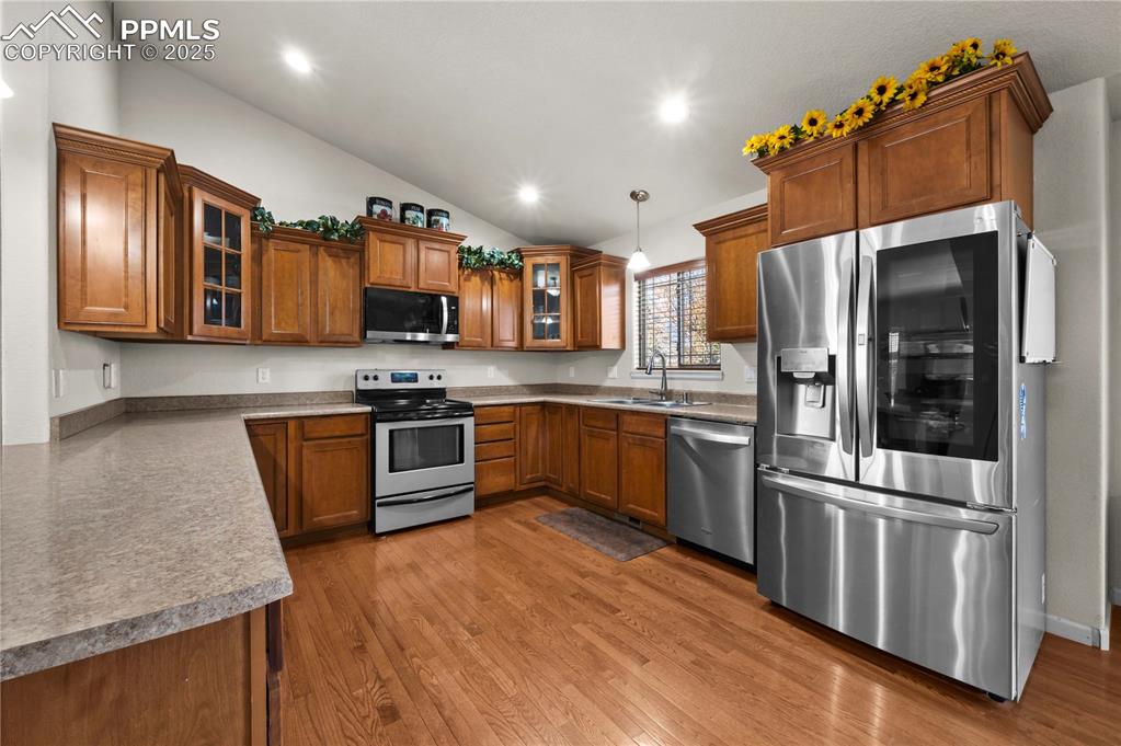 Image 8 of 35: Beautiful kitchen with stainless steel appliances and vaulted ceilings