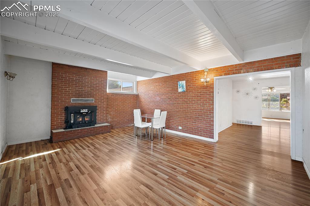 Image 12 of 31:  Living room with brick wall, healthy amount of natural light, fire place a