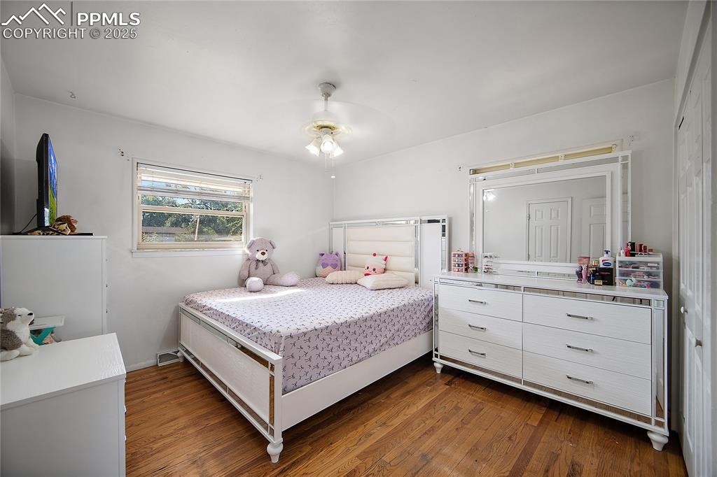 Image 16 of 31: Bedroom featuring dark wood-style flooring and ceiling fan