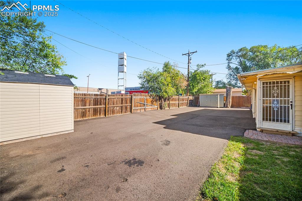 Image 24 of 31: View of patio featuring a storage unit