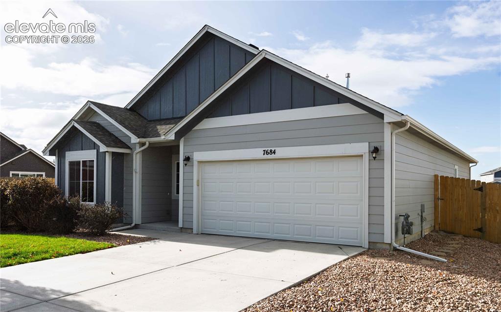 Image 2 of 40: Wide driveway with gravel extension to the side