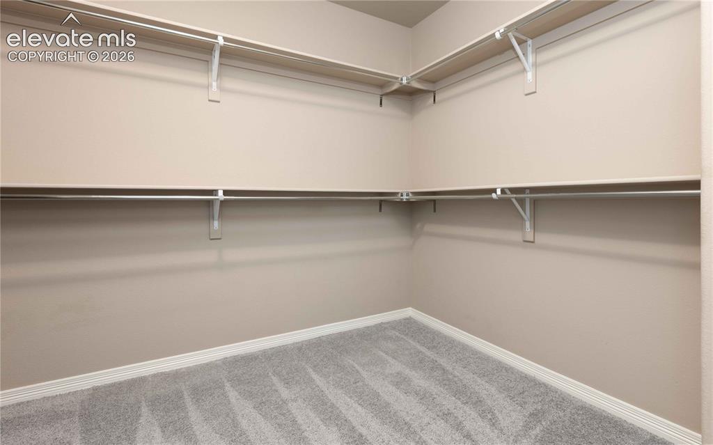 Image 23 of 40: Walk in closet for primary bedroom