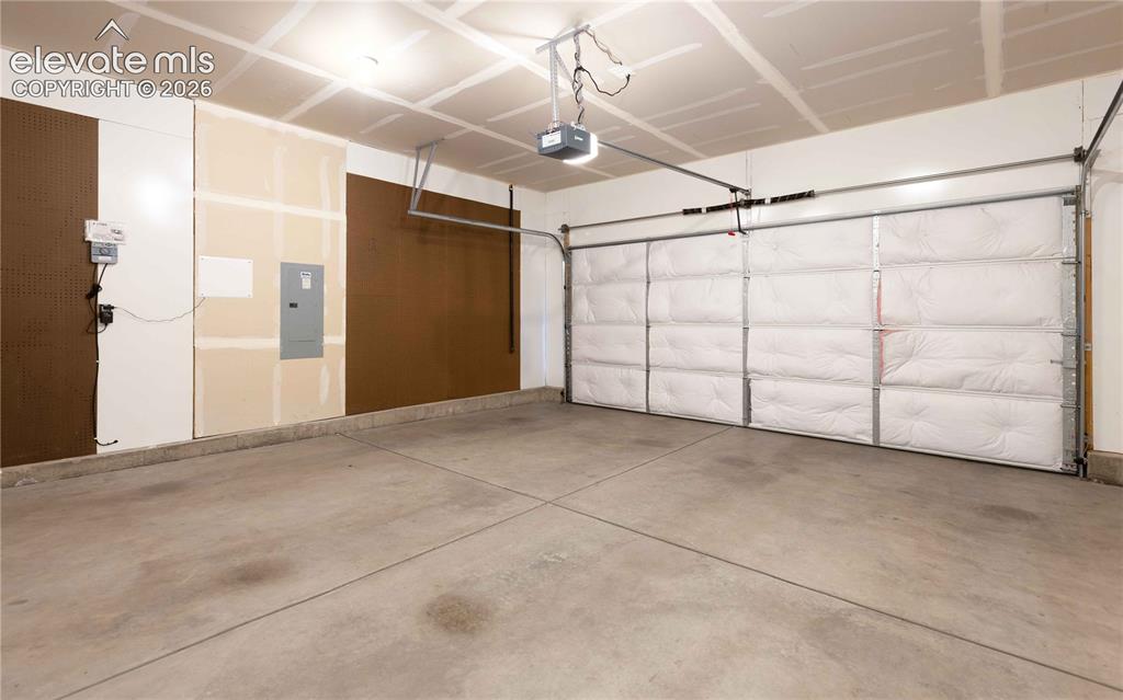 Image 26 of 40: Large garage with insulated doors