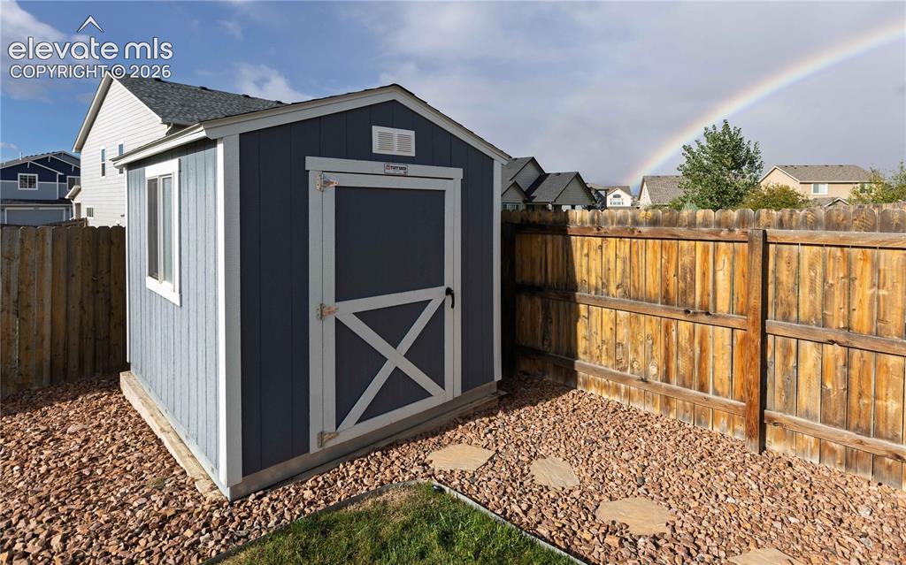 Image 28 of 40: Well kept storage shed.
Not AI.. photographer caught the rainbow