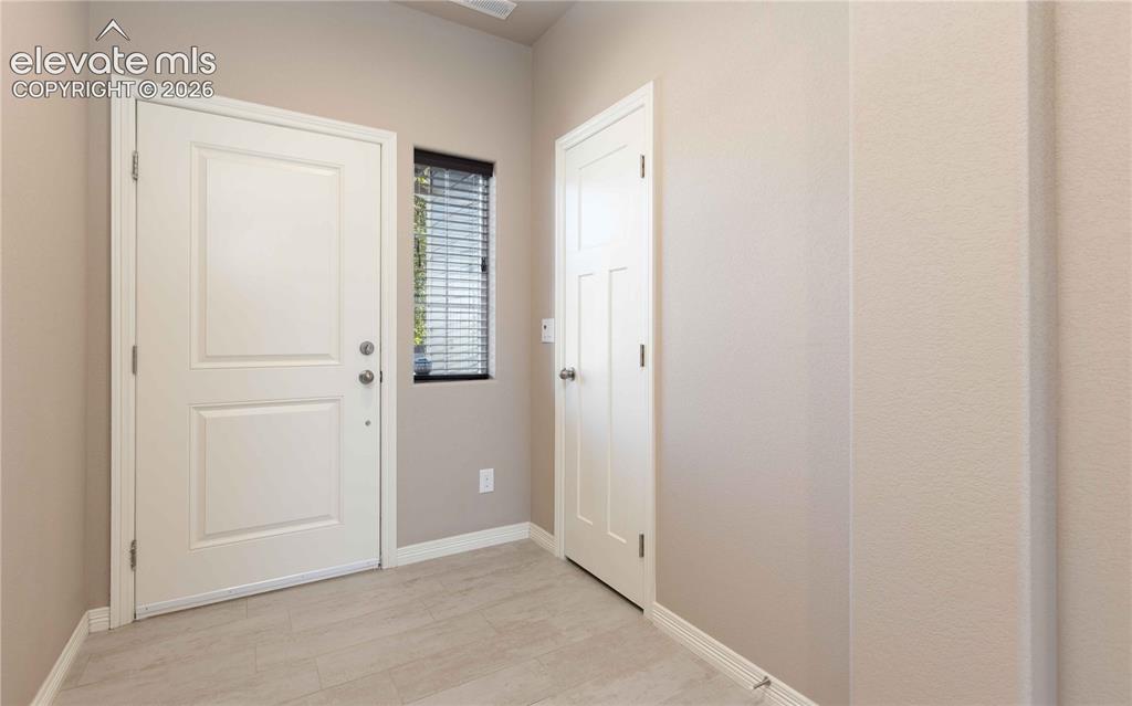 Image 4 of 40: Wide welcoming foyer leads to hallway