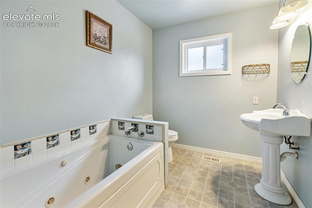 Image 16 of 32: 3/4 bathroom with jetted tub