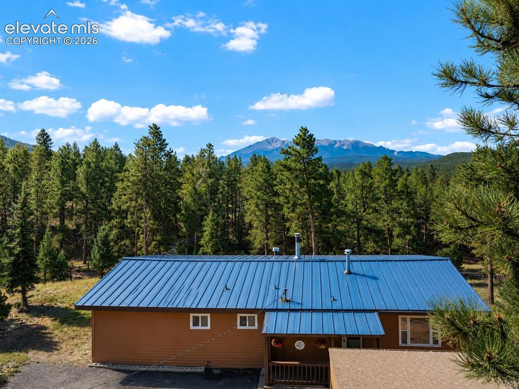 Image 3 of 32: Front of property and Pikes Peak ariel view