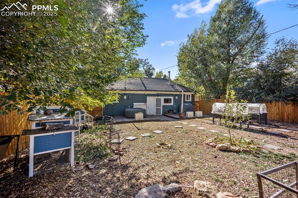 Image 33 of 41: Back of house with a fenced backyard, a patio, roof with shingles, and an o