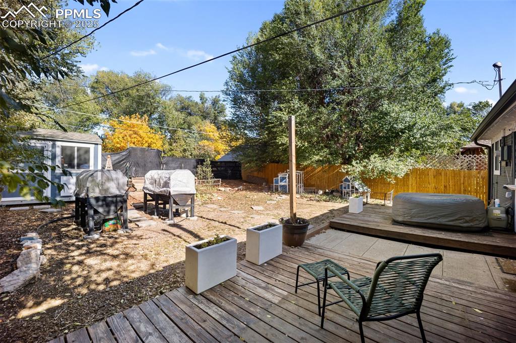 Image 35 of 41: Deck featuring a fenced backyard, an outbuilding, a patio, and grilling are