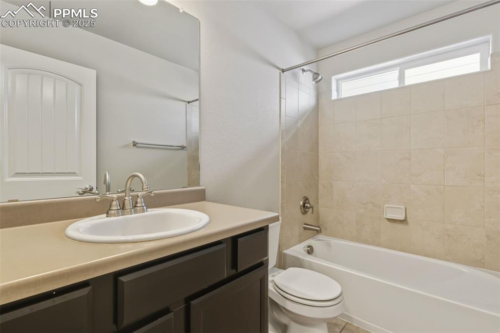 Image 11 of 27: Full bath featuring vanity and shower / tub combination