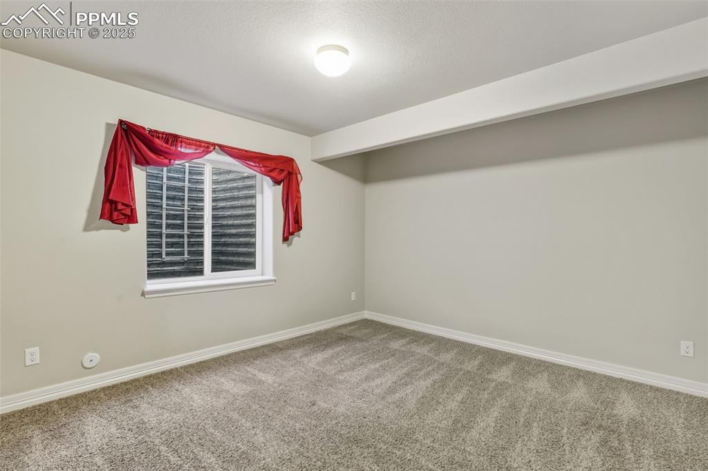 Image 20 of 27: Spare room with baseboards and carpet floors