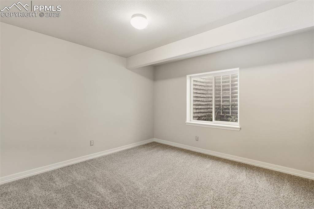 Image 22 of 27: Empty room with baseboards and carpet