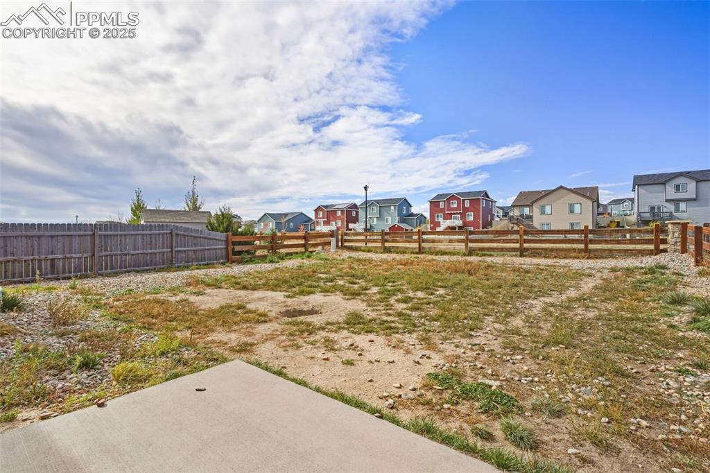 Image 25 of 27: View of yard featuring a residential view and a patio