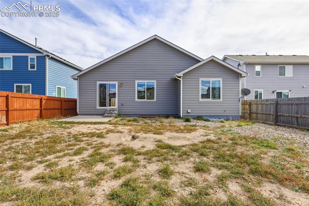 Image 26 of 27: Back of house featuring a patio and a fenced backyard