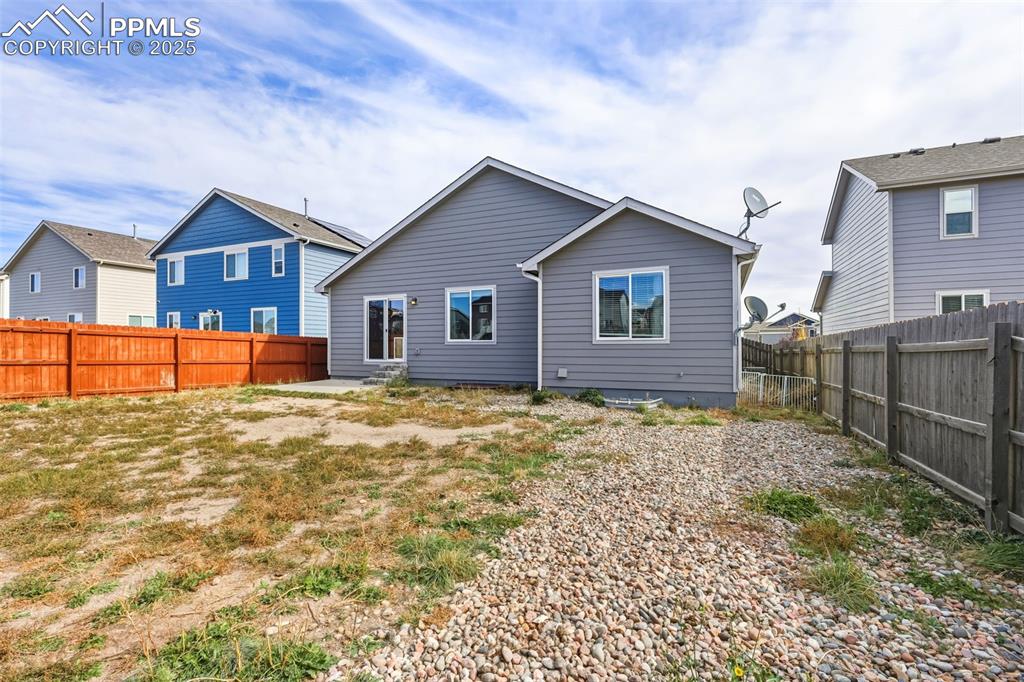 Image 27 of 27: Back of property featuring a fenced backyard and a patio area