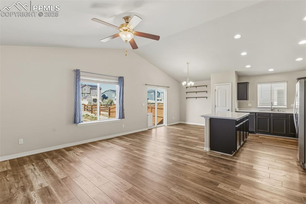 Image 4 of 27: Kitchen featuring a center island, plenty of natural light, a chandelier, o